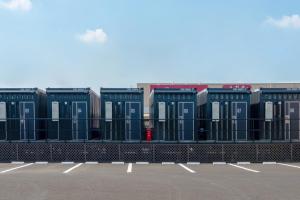 a row of shipping containers in a parking lot at HOTEL R9 The Yard Isesaki in Isesaki