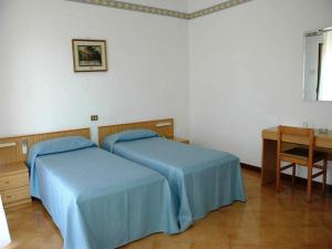 A bed or beds in a room at Hotel Le Pelagie