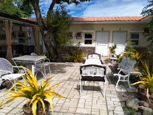 a patio with chairs and tables in front of a house at Casa FAM in Laoag