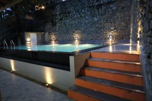 a swimming pool in a building at night with lights at Kandy Wellington Apartment in Kandy