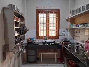 a kitchen with a sink and a window at Govind Niwas Home Stay in Gwalior