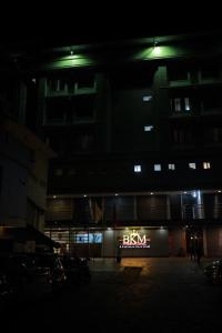 a building with a baxter sign in front of it at night at Hotel BKM International in Tellicherry