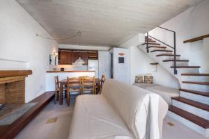 a living room with a couch and a dining room at Ionian Colours Kefalonia in Kontogouráta
