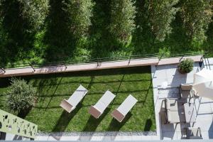 an overhead view of a lawn with chairs and tables at Oliven- & Genusshotel Hirzer in Schenna +71 photos