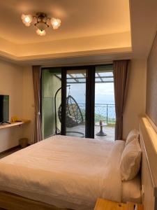 Shuilian的住宿－錦水山海莊民宿，一间卧室设有一张床和一个大窗户