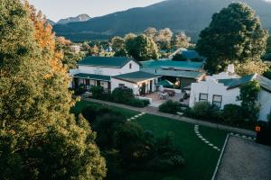 an aerial view of a house in the mountains at The Village Lodge in Stormsrivier