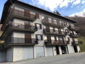 a building with balconies on the side of it at Residenza Maria in Ala di Stura