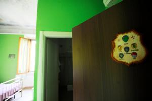 eine Uhr an einer grünen Wand in einem Zimmer in der Unterkunft B&B Calcio Storico in Florenz