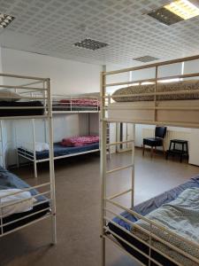 a room with three bunk beds and a desk at SM Hostel in Reykjavík