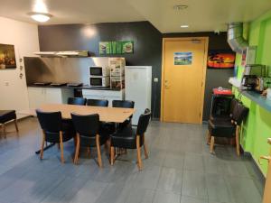 a room with a table and chairs and a kitchen at SM Hostel in Reykjavík