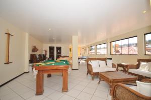 a living room with a pool table and couches at Rio Búzios Beach Hotel in Búzios