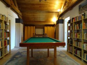 a pool table in the middle of a library at Au Catalpa in La Chapelle-Faucher