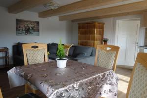 a living room with a table and a couch at Ferienhaus Belvedere in Hainewalde