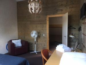 a room with a bedroom with a table and a chair at Vakantiehuis bij Bedaf in Uden