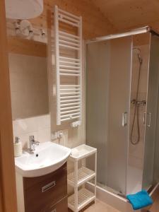 a bathroom with a sink and a shower at Domki przy jeziorze Wejsuny in Ruciane-Nida