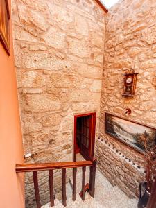 a staircase in a stone building with a fireplace at Casa da Tanquinha in Beiral do Lima