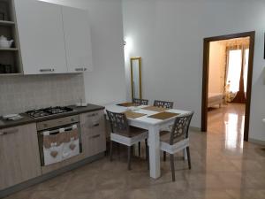 a kitchen with a table and chairs and a stove at LaRosa Maruggio in Maruggio