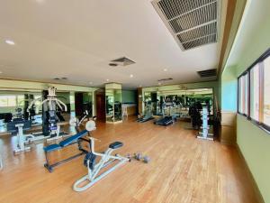 a gym with several treadmills and machines in a room at PMY Beach Resort in Rayong