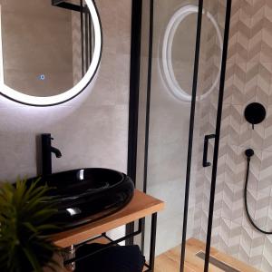 a bathroom with a black sink and a shower at Boutique Villa Revelin in Pag