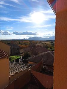 a view of the mountains from the roofs of houses at Alojamiento rural LA JARA 2 in Robledillo de la Jara