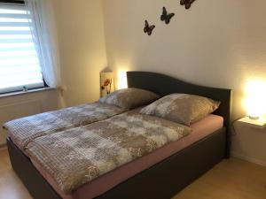 a bed in a bedroom with two pillows on it at Haus Osterwiese in Lüneburg