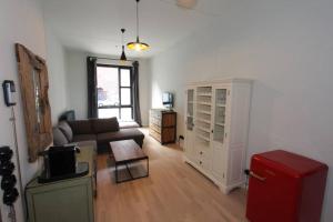 a living room with a couch and a red refrigerator at Stylisches Loft-Apartment mitten in Berlin in Berlin