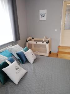 a bedroom with a bed with pillows on it at Apartament nad Gorczańskim Strumieniem in Koninki