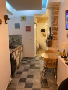 a kitchen and dining room with a table and a counter at Appartement secret , Cathédrale Saint Benigne Au calme in Dijon +13 photos