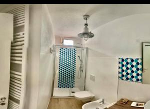 a bathroom with a shower and a toilet and a sink at Casa sui Tetti in Ozieri