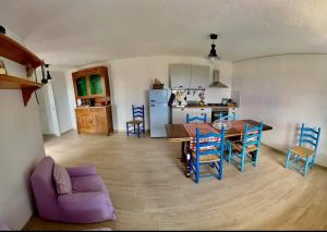 a kitchen and dining room with a table and chairs at Casa sui Tetti in Ozieri +66 photos