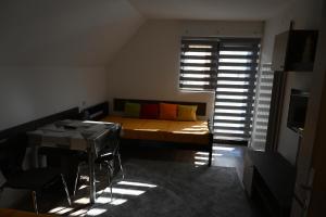 a bedroom with a bed and a table with chairs at Apartman Vukašin in Kopaonik