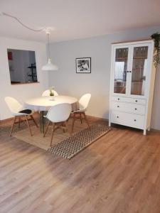 a dining room with a white table and chairs at Apartment Heddesheim in Heddesheim