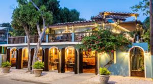 a house with a balcony and a restaurant at Puertas in Vieques
