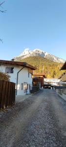 a building with a mountain in the background at Apartment Martina in Telfs