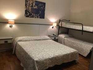 Postel nebo postele na pokoji v ubytování Hotel Ai Tufi