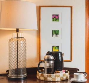 a lamp sitting on a table next to a coffee maker at Puertas in Vieques