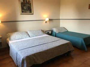Postel nebo postele na pokoji v ubytování Hotel Ai Tufi