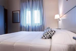Postel nebo postele na pokoji v ubytování Hotel Ai Tufi