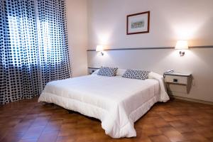 Postel nebo postele na pokoji v ubytování Hotel Ai Tufi