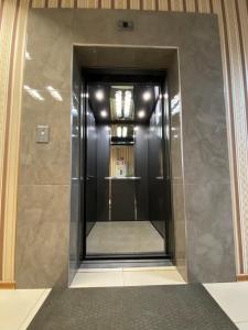 een lift in een gebouw met een spiegel bij Passage Hotel in Ternopilʼ