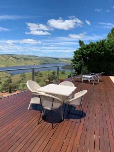 a wooden deck with a table and chairs on it at Amazing Views Pet Friendly Bed and Breakfast in Yass