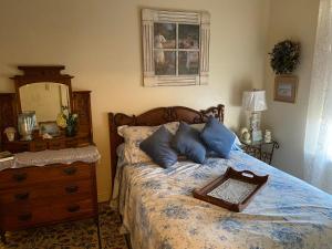 1 dormitorio con 1 cama con tocador y espejo en The Hotel Texan, en Seagraves