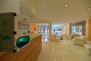 a living room with a tv on a wall at BALOO Hotel in Mar del Plata