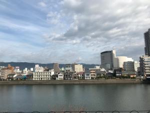a city with buildings and a body of water at 鏡水旅館/kyousuiryokan in Kochi
