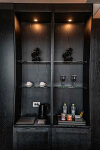 a kitchen with a shelf with glasses and a coffee maker at Best Louis Hamilton Hotel West Busan in Busan