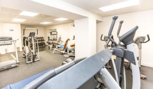 a gym with treadmills and elliptical machines at Ocean Eleven Deluxe in Mount Maunganui
