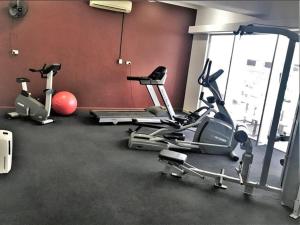 a gym with three exercise bikes in a room at Inner city Cardona Court apartment in Darwin