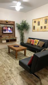 a living room with two couches and a coffee table at Praia das Cigarras São Sebastião a 50 metros da praia - Wi-Fi - 500 Mega in São Sebastião