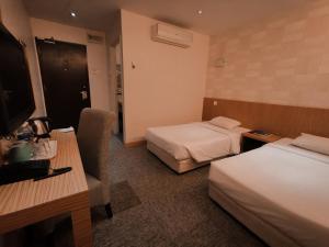 Postel nebo postele na pokoji v ubytování Prescott Hotel Bukit Bintang