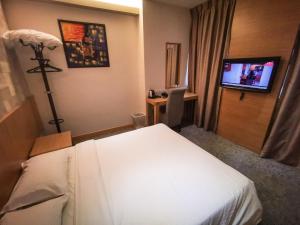 Postel nebo postele na pokoji v ubytování Prescott Hotel Bukit Bintang